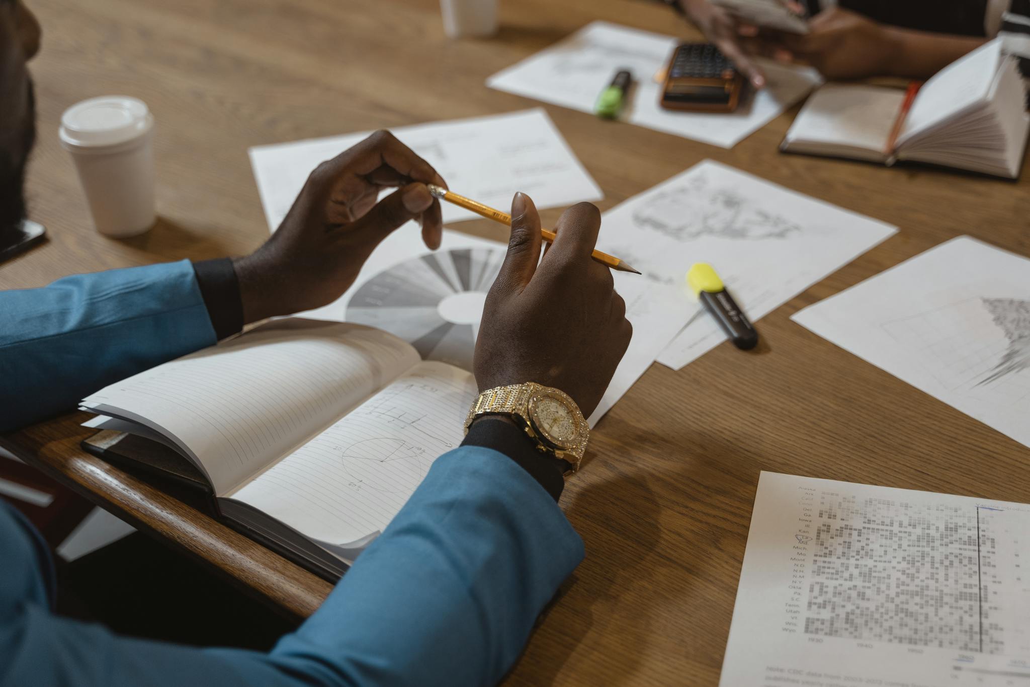Team members engaging in a collaborative business meeting with documents and notes.